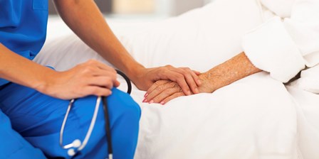 medical doctor comforting senior patient